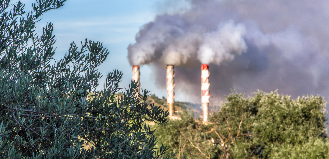 Factory smokestack pollution in nature